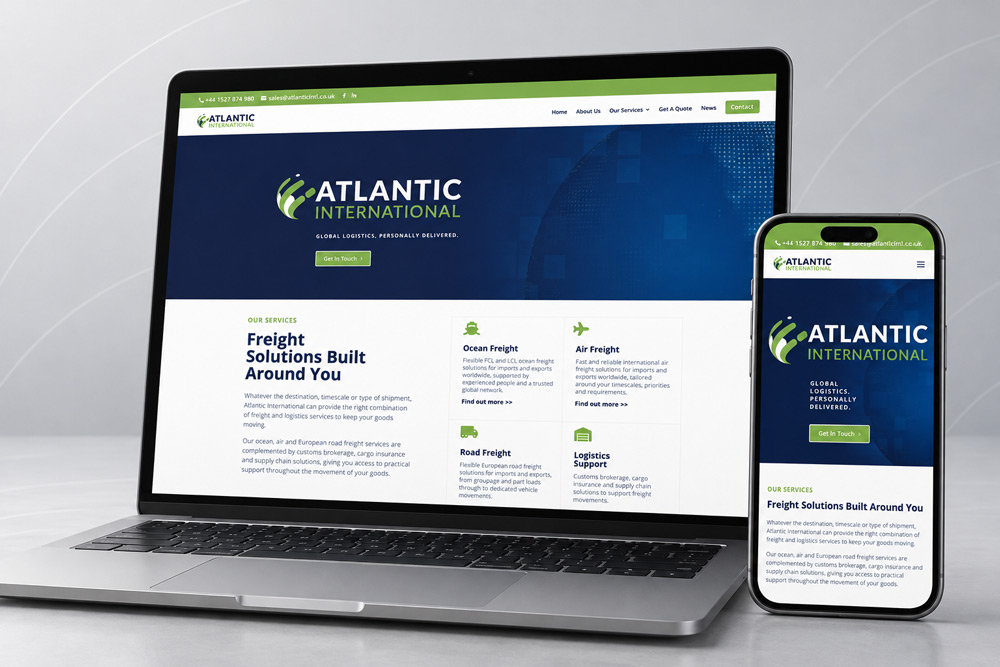 New Atlantic International website displayed on a laptop and smartphone