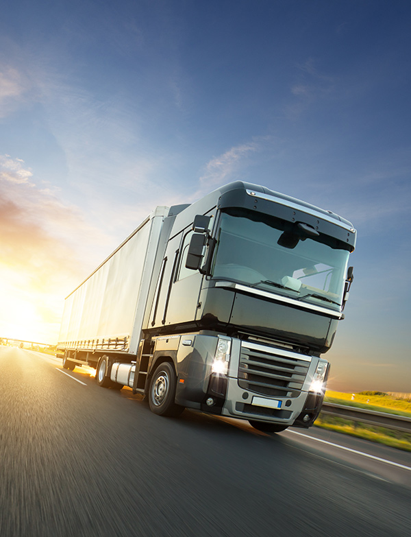 Articulated lorry travelling along a motorway, illustrating European road freight transport