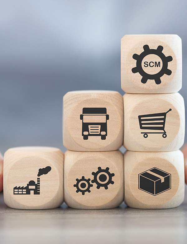Wooden blocks showing transport, packaging, manufacturing and shopping symbols, representing logistics support and supply chain management