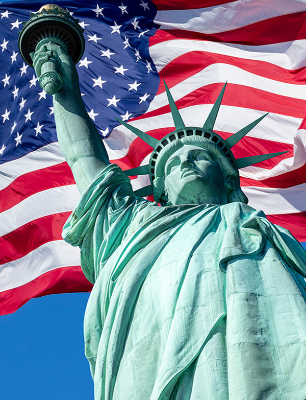 Statue of Liberty against the American flag, illustrating Atlantic International’s DDP shipping to USA service